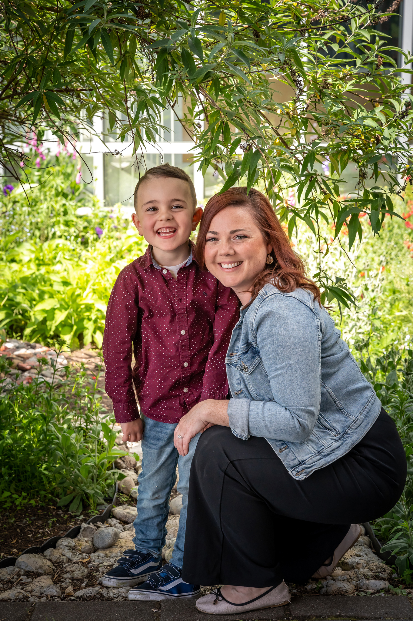 Mom and son smiling under the overhang of a tree. Spring smiles from everyone!