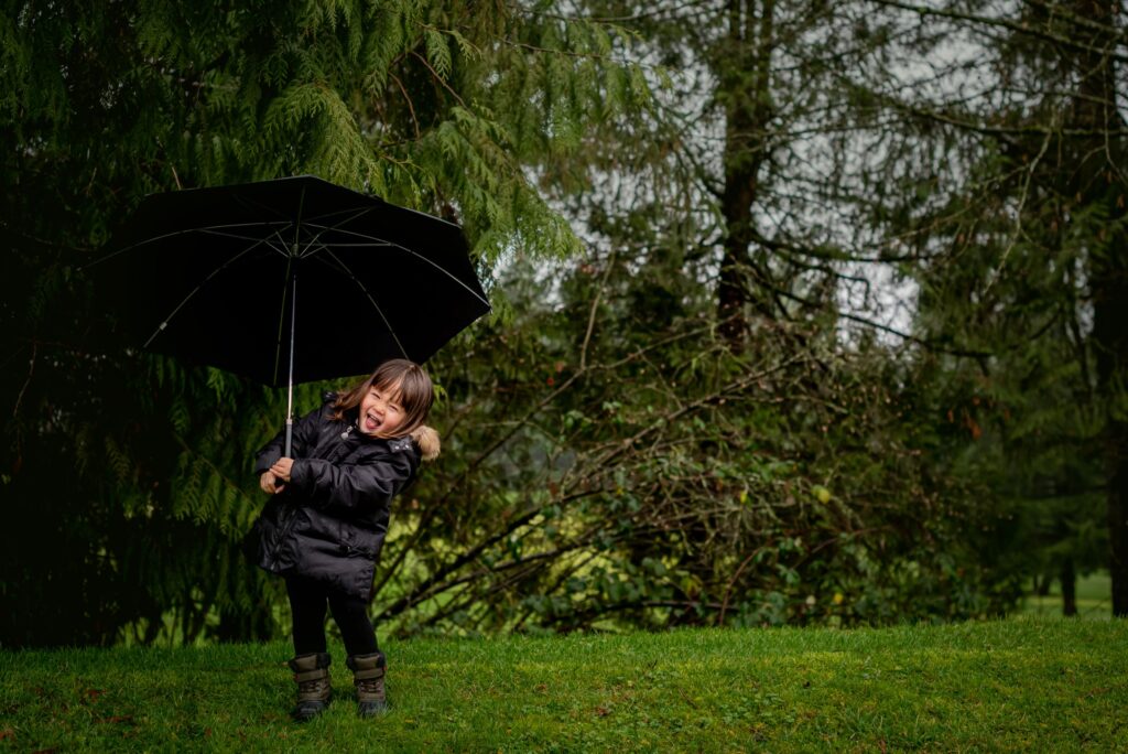 Family with young children playing in a park during a fall photo session in Port Coquitlam, BC