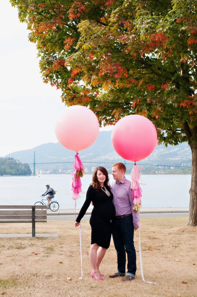 Pregnant woman in a fitted dress posing for a maternity photo session in Vancouver during fall